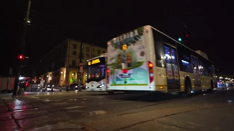 Moving shot of bus passing by at night 스톡 동영상 235399253