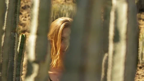 Moving Shot of Charimng Model Smiling Behind Cacti Stock Footage 114175697