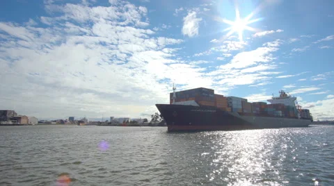 Moving shot of container ship leaving a port Stock Footage 67579494