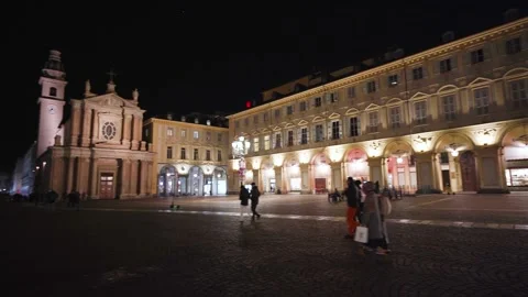 Moving shot of an empty and illuminated square at night with churches Stock Footage 235398029