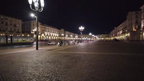 Moving shot of an empty and illuminated square at night with tram 스톡 동영상 235398530