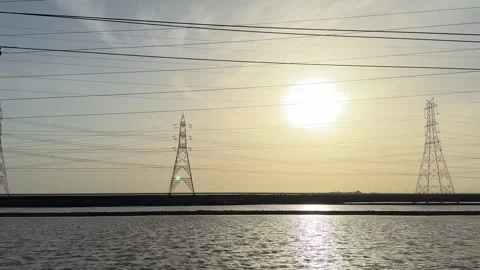 Moving Shot of Power Lines and Industrial Pylons at Sunset in Rann of Kutch Stock Footage 331800762