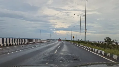 Moving shot of red car overtaking on highway capturing smooth motion and sc.. Stock Footage 336365702