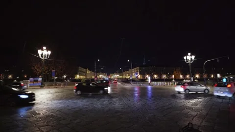 Moving shot of a square with traffic at night 스톡 동영상 235399699