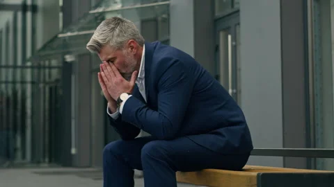 Moving shot stressed middle aged senior Caucasian business man headache pain Stock Footage 253184374