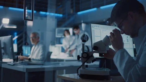 Moving Shot in Technology Research Laboratory, Specialist Uses Microscope 動画素材 104847225