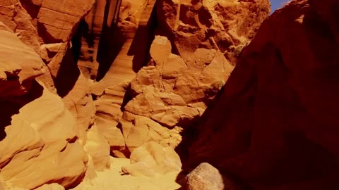 Moving shot through narrow orange sandstone slot canyon passage Stock Footage 329558809