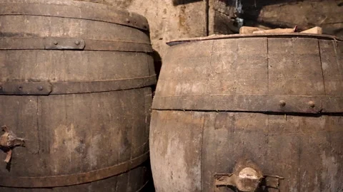 Moving Shot of Two Wine Barrels in Old Cellar Stock Footage 345989213