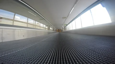 Moving sidewalk inside corridor with sunshine from windows Video stock 55211116
