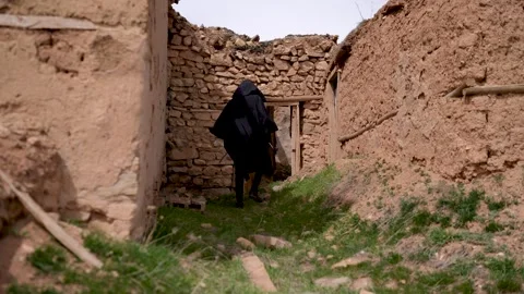 Moving Silhouette of a Man in a black hood wandering through an old abandon.. Stock Footage 241731853