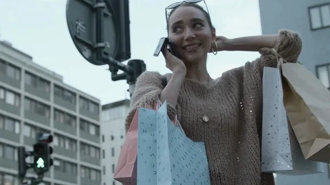 Moving slow motion shot of a young beautiful shopper on the phone. Stock Footage 116495200