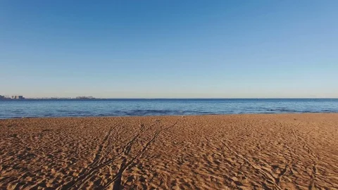 Moving slowly along the sandy beach toward the sea. Stock Footage 82808355