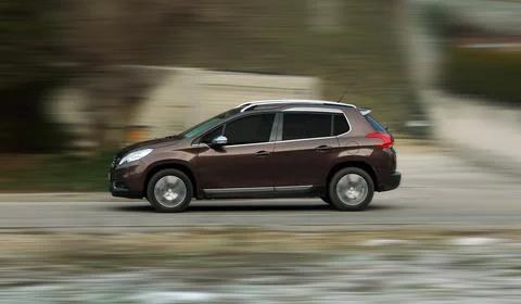 Moving small brown car Stock Photos