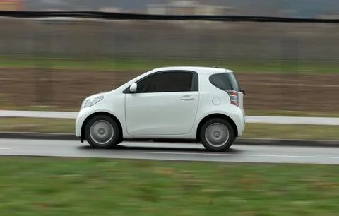 Moving small white car Фото