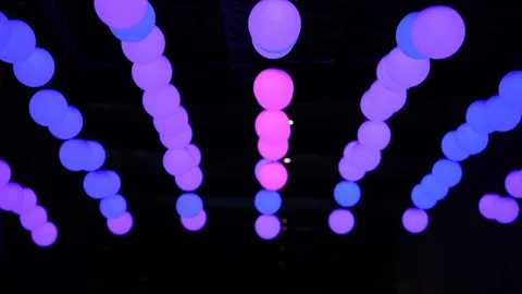 Moving spheres of light changing colour, red, purple, blue, during night disp Stock Footage 128400720