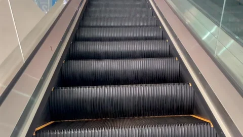 Moving steps of empty escalator going up in public building 스톡 동영상 343174762