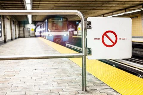 Moving subway train and motion blur with safety interdiction sign. Stock-Fotos