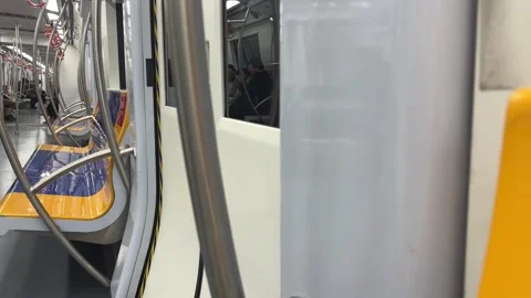 Moving Subway Train Interior with Door, Seats, and Passenger Reflections Stock Footage 331486914