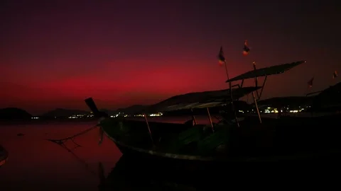 Moving Thai flag and red light blinker on long tail boat park on sea beach wi Stock Footage 99008594