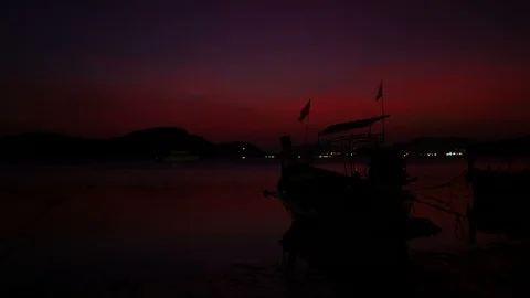 Moving Thai flag on long tail boat park on sea beach with low tide sea and si Stock Footage 99008494