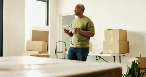 Moving, thinking or black man with tablet in new home, interior design Stock Footage 336796697