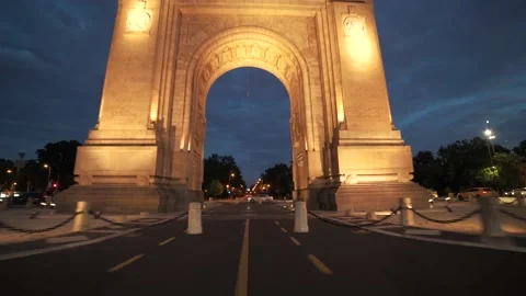 Moving through the Arch of Triumph Bucharest Square during pandemic at dusk Stock Footage 157153372