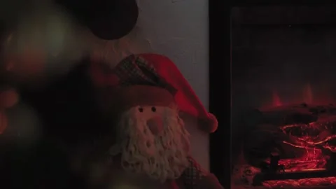Moving through a Christmas tree to Santa Claus and fireplace Stock Footage 144660160