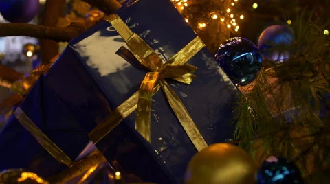 Moving through christmas tree towards a gift parcel Video stock 58061817