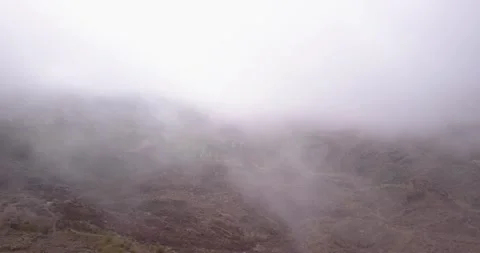 Moving through Clouds in Rocky barren Mountain Valley  in Europe Vídeo Stock 135907078