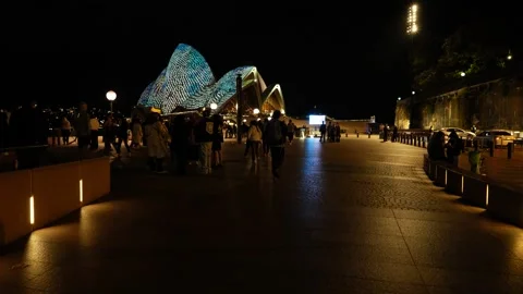 Moving through crowds towards Sydney Opera House during VIVID 6K Stock Footage 311120526