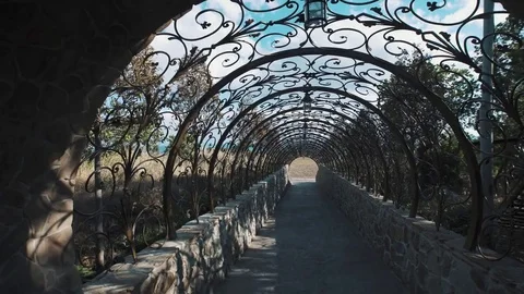 Moving through decorative tunnel bow made of metal in designed patterns 스톡 동영상 73606469