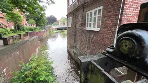 Moving Through Historic Canal Lock Beside Old Brick Building, 4K Stock Footage 339794864