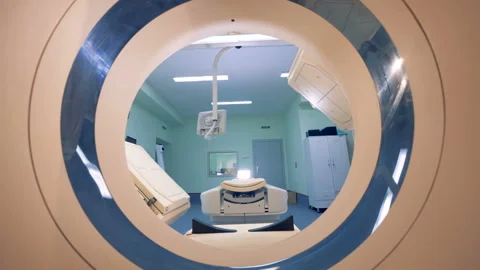 Moving through the scanner bore of a tomographic machine towards its bed and Stock Footage 90705817
