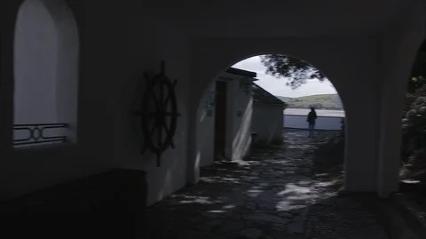 Moving through stone arches and window with view of the sea Video stock 128501173