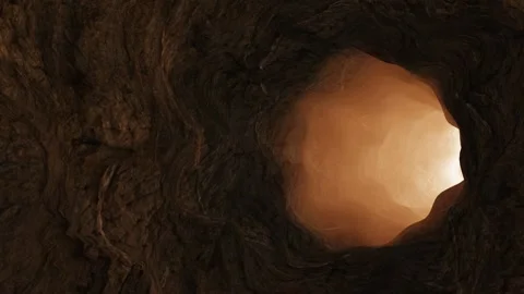 Moving through a tunnel cave of rocks towards exit and light Stock Footage 249265506