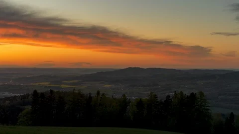 Moving timelapse of sunset over the town wide view of surrounding countryside Stock Footage 130090278