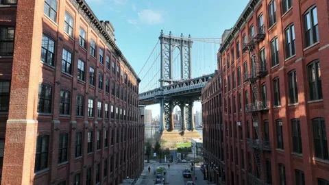 Moving toward Empire State Building framed Manhattan Bridge from Brooklyn NYC Stock Footage 186923751