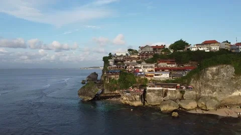 MOVING IN TOWARDS TOWN ON CLIFF Stock Footage 221300415