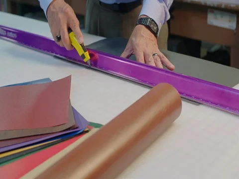 Moving Towards Worker Grabbing Knife and Cutting Paper Stock Footage 80208733