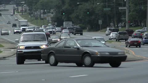 Moving traffic, compressed, 8-lanes, left turns in foreground Stock Footage 10833327