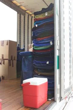 Moving trailer with packed boxes on floor and moving blankets Stock Photos