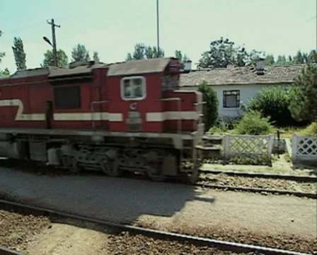 Moving train coming to a stop by buildings Stock Footage