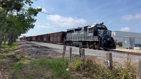 Moving Train going through signal on street Volusia County Stock Footage 237128344