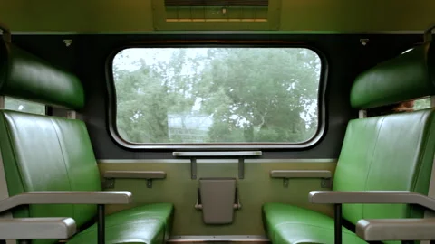 Moving train with green seats interior and trees in the background Stock Footage 269937439