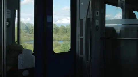 Moving train inside. Outside, a bright sun and landscapes, inside is dark Stock Footage 76314143