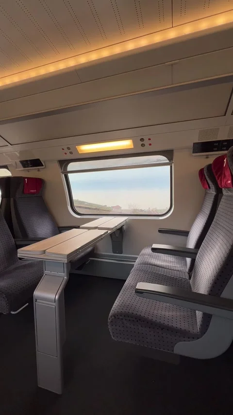 Moving train interior view, 1st class, empty seats and small window Stock Footage 305506964