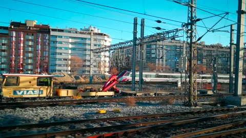 A moving train leaving a station and another train entering it. Stock Footage 169716206