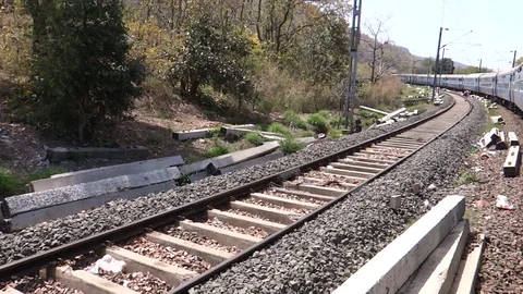 Moving train pov, man walking on a parallel track in India Stock Footage 114975913