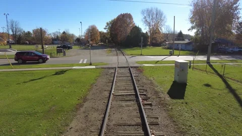 Moving Train Tracks Over Intersection Through Small Canadian Town With Canad Video stock 247507788