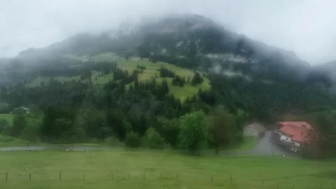 Moving Train View of Misty Alpine Mountains Stock Footage 328129687